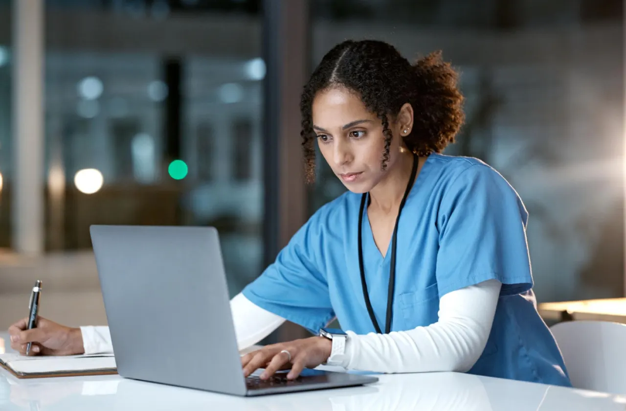 nurse-working-laptop-at-night-office-radha-patel-np-reviews