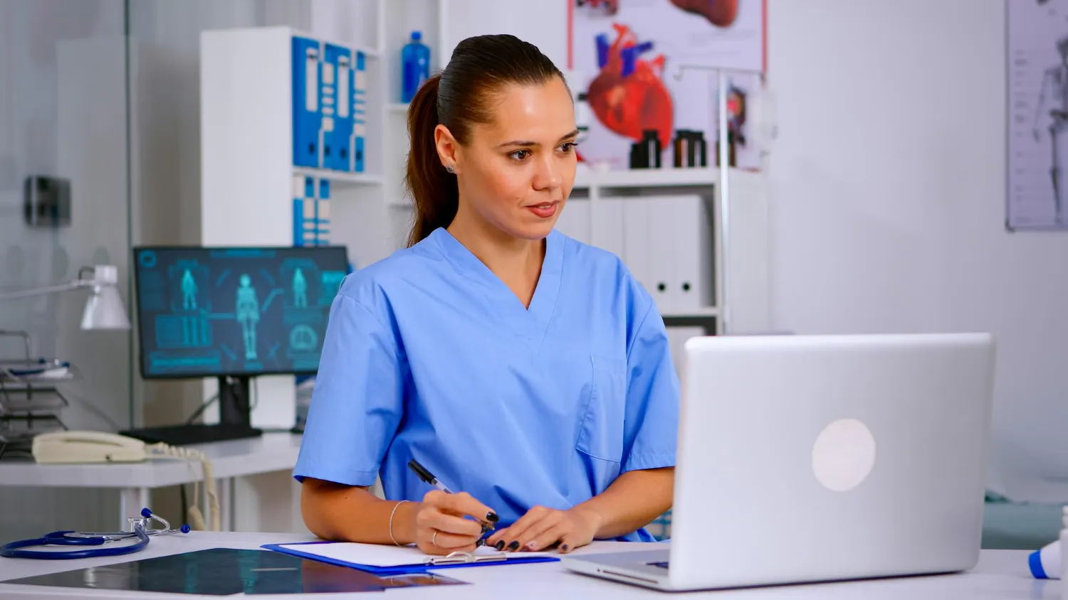 nurse-working-laptop-in-office