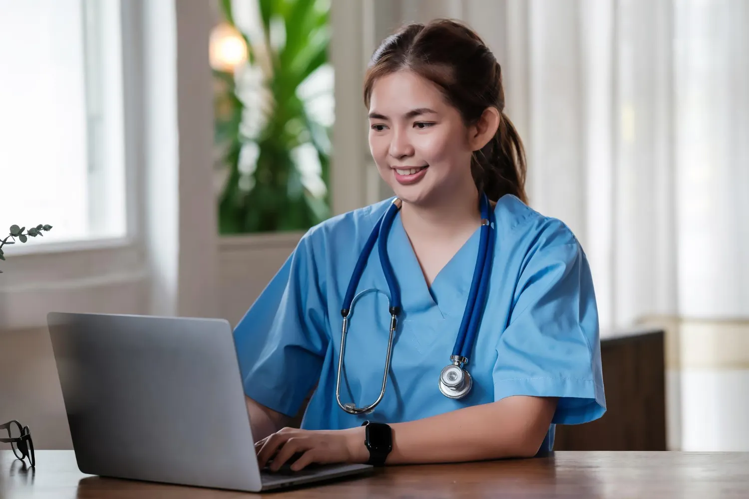 nurse-working-on-laptop-at-desk-radha-patel-np-reviews